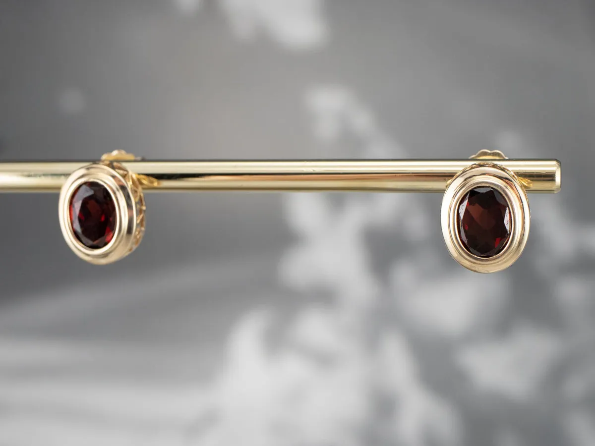 Bezel Set Garnet Stud Earrings in Yellow Gold
