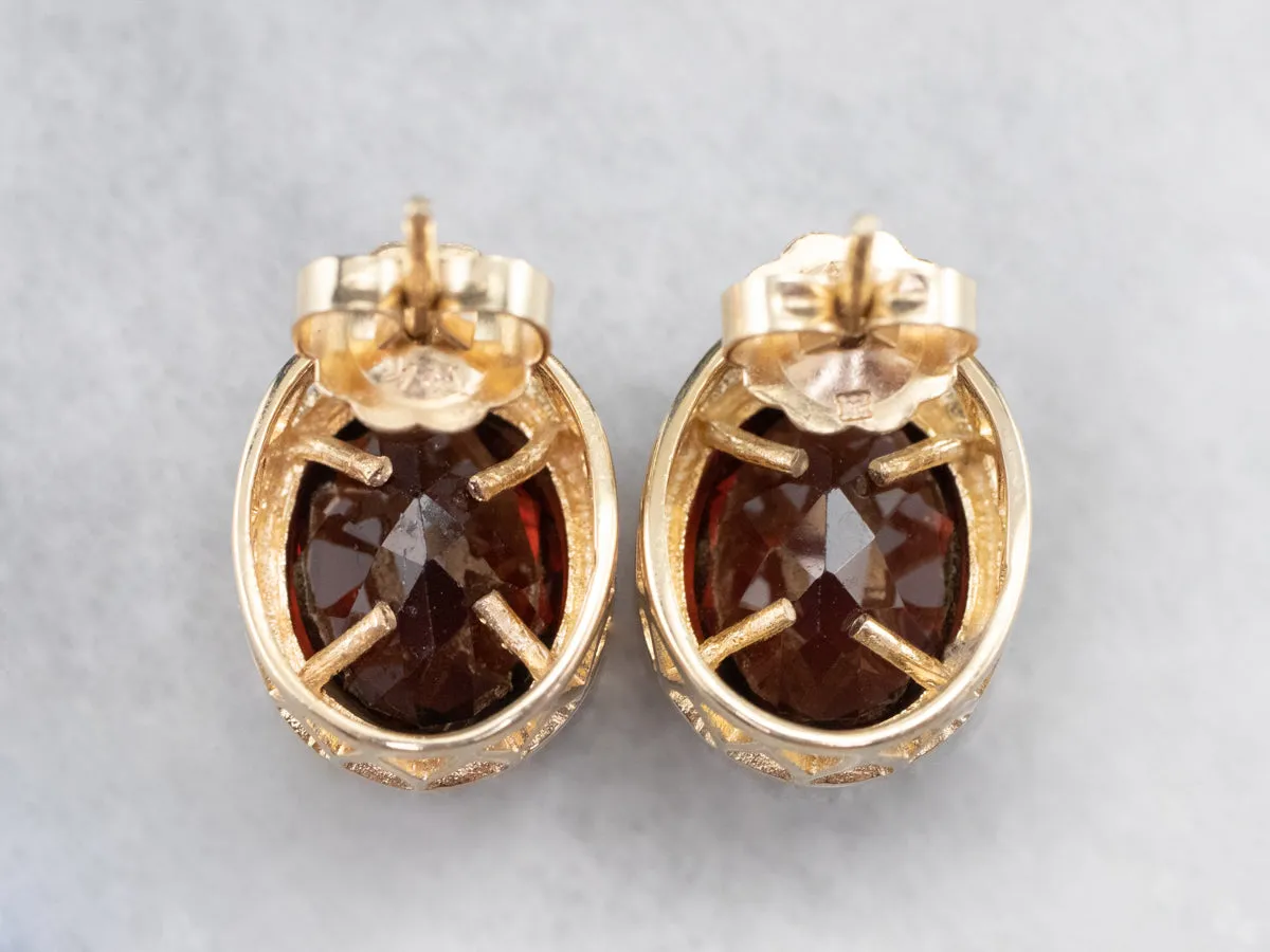 Bezel Set Garnet Stud Earrings in Yellow Gold