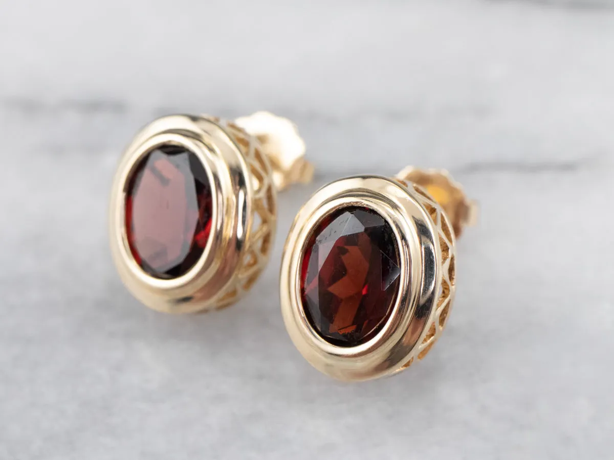 Bezel Set Garnet Stud Earrings in Yellow Gold